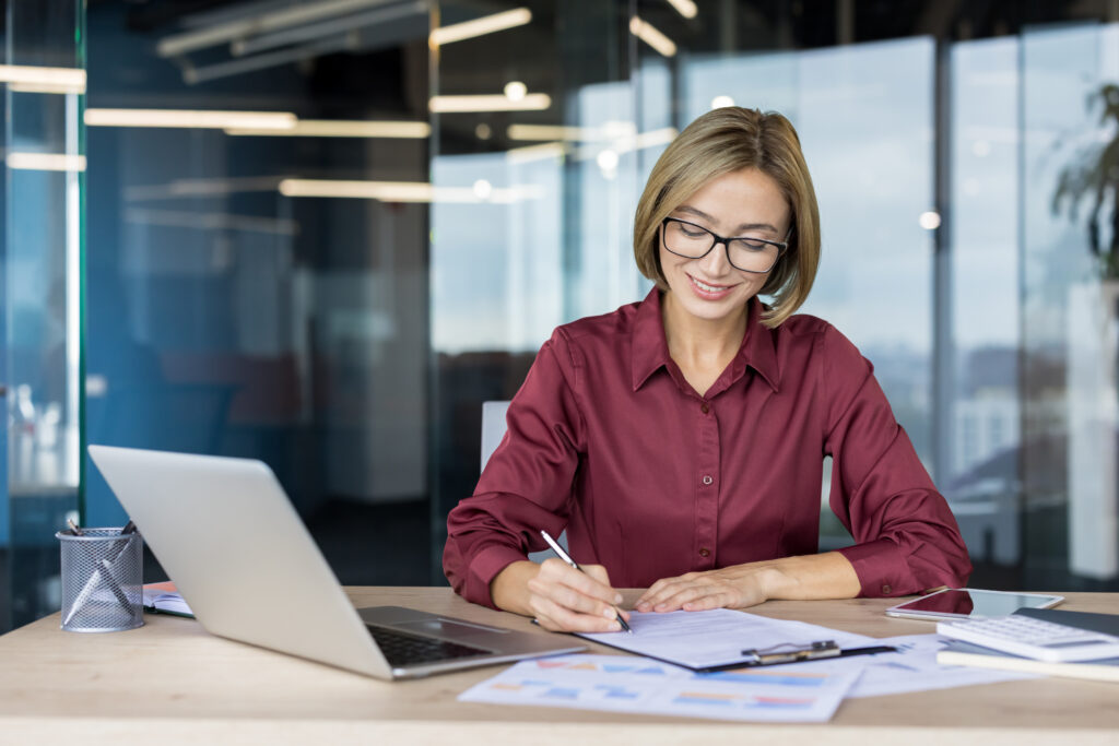 Professional Businesswoman In Office Signing Important Document